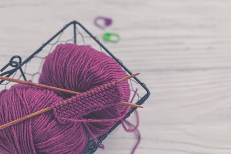 Background with knitting tools and accesories, colorful purple skein yarn, hobby concept, copyspaceの写真素材