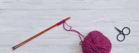Background with knitting tools and accessories, colorful skein yarn, hobby concept, copyspace, top viewの写真素材