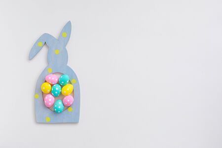Composition of Easter bunny rabbit frame and colorful polka dot eggs, flat lay, Happy Easter sale or greeting concept postcard with copy spaceの写真素材
