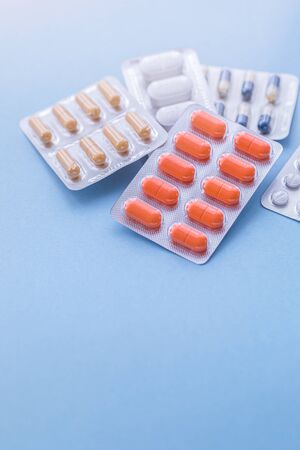 Tablets and pills on blue background, medicine drugs concept, copy spaceの写真素材