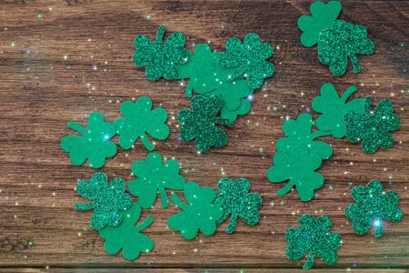 St Patrick day background with shamrock clover leaf on wood, Irish festival symbol, toned, copyspace
