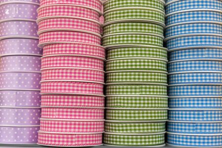Pastel color checked and polka dot ribbon bobbins background, hobby sewing design conceptの写真素材