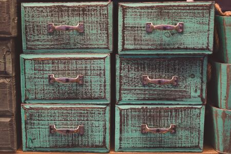 Vintage green and brown colored and toned wooden drawers backgroundの写真素材