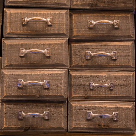Vintage brown colored and toned wooden drawers backgroundの写真素材