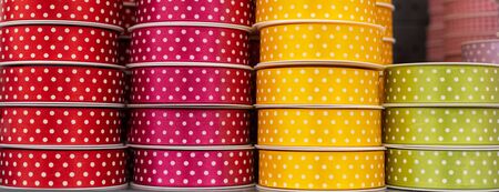 Colorful polka dot ribbon bobbins background, hobby sewing design conceptの写真素材