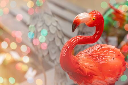 Colorful artificial ceramic flamingo toy, holiday home and garden decor concept, greeting, postcard with copyspaceの写真素材