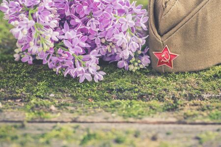Traditional field cap on natural moss background, symbol of Victory Day, May 9, selective focusの写真素材