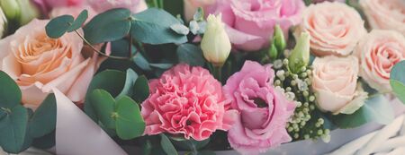 Pastel trend colored flowers in white basket isolated, floristic wedding present background, March 8, Womens, Mothers day postcard conceptの写真素材