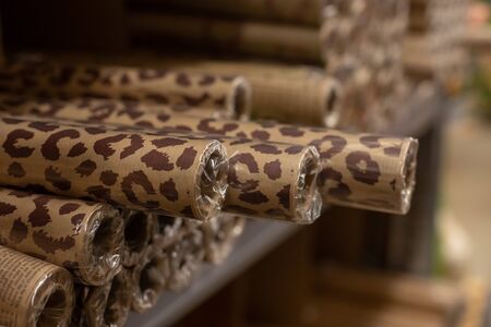 Brown wrapping paper rolls with trended jaguar skin texture, shopping background concept