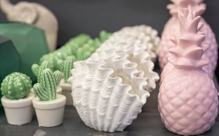 Trendy pastel color exotic pineapple, shell and cactus shaped ceramic vases, Arte Deco style home decor, selective focus, tonedの写真素材