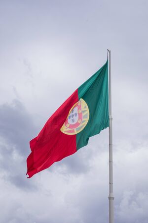 Portuguese Flag flapping in the wind in the sky landscape
