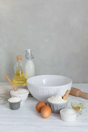 Ingredients for bakery making pancakes flour milk sugar eggs, kitchen accessories, copyspace, selective focusの写真素材