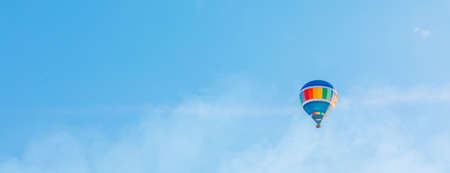 Colorful hot air balloon flying in the sky in summerの写真素材