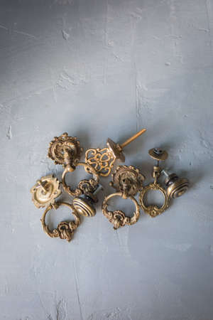 Vintage furniture accessories - door handles on the concrete background, tonedの写真素材