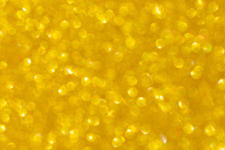 Golden abstract background with bokeh defocused lightsの写真素材