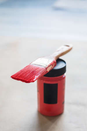 Red colored brush and pint bottle on wooden background, selective focus, mockup, tonedの写真素材