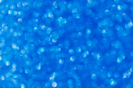 Vivid blue abstract background with bokeh defocused lightsの写真素材