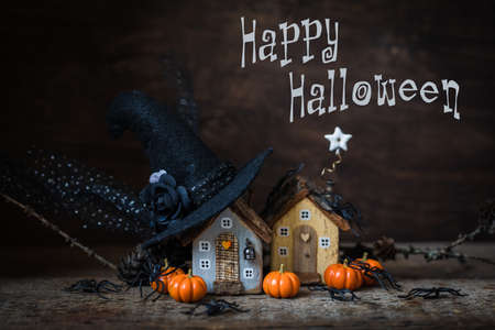 Miniature Halloween little autumn cottages, pumpkins, spiders, moss backgroundの写真素材
