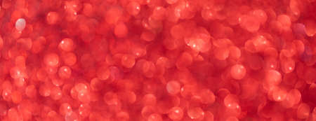 Vivid red Christmas abstract background with bokeh defocused lightsの写真素材