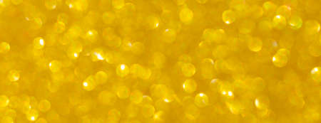 Golden abstract background with bokeh defocused lightsの写真素材