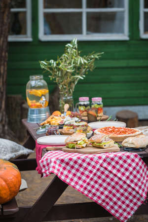 Assorted Italian food table setting in the garden, delicious snack on party or picnic time conceptの写真素材