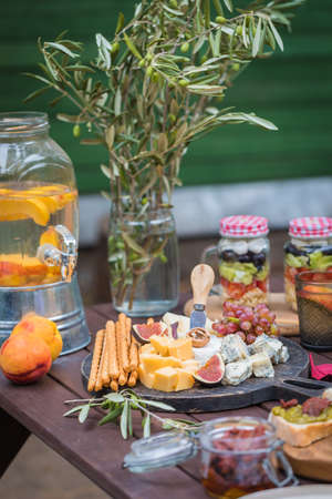 Assorted Italian food table setting in the garden, delicious snack on party or picnic time conceptの写真素材