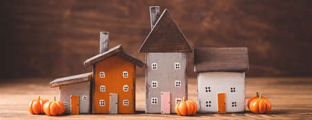 Miniature Thanksgiving Day little cozy fairy tale autumn cottages, pumpkins, wooden background, postcard concept, tonedの写真素材