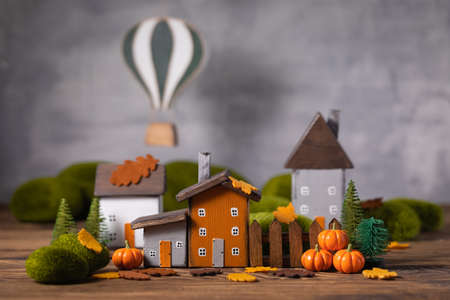 Miniature Thanksgiving Day little fairy autumn cottages, pumpkins, air balloon wooden background, postcard concept, tonedの写真素材