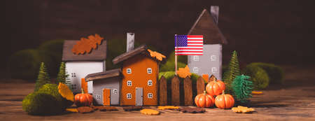 Miniature Thanksgiving Day little fairy autumn cottages, pumpkins, USA national flag, wooden background, postcard concept, tonedの写真素材