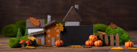 Miniature Thanksgiving Day little fairy autumn cottages, pumpkins, copyspace, wooden background, postcard concept, tonedの写真素材