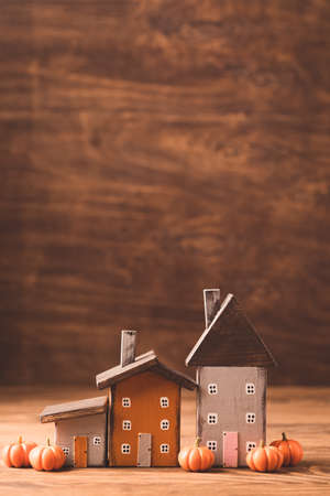Miniature Thanksgiving Day little cozy fairy tale autumn cottages, pumpkins, wooden background, postcard concept, tonedの写真素材