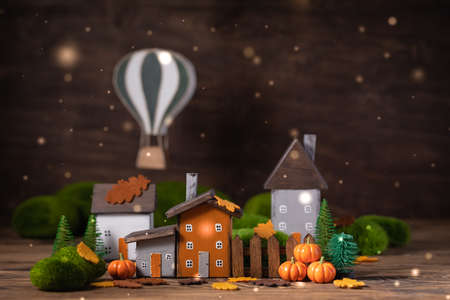 Miniature Thanksgiving Day little fairy autumn cottages, pumpkins, air balloon wooden background, postcard concept, tonedの写真素材