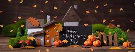 Miniature Thanksgiving Day little fairy autumn cottages, pumpkins, copyspace, wooden background, postcard concept, tonedの写真素材