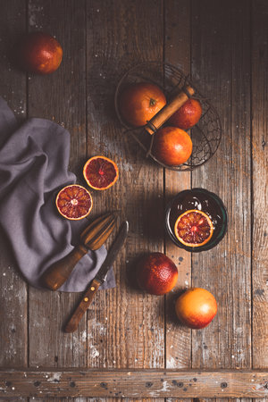 Sliced Sicilian Blood oranges fruits over old dark wooden background. Top viewの写真素材