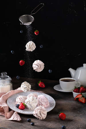Traditional Russian homemade merengue marshmallow or zephyr on a plate on wooden background. Copy space.の写真素材