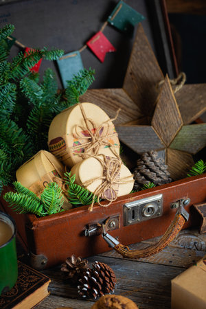 Christmas vintage suitcase with books, presents on wooden backgroundの写真素材