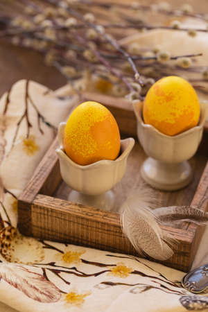 Dyed Easter eggs with marble stone effect painted with natural dye by turmeric on old backgroundの写真素材