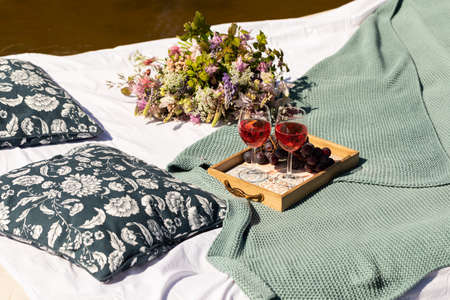 Romantic summer lunch on a mattress floating in the lake or pondの写真素材
