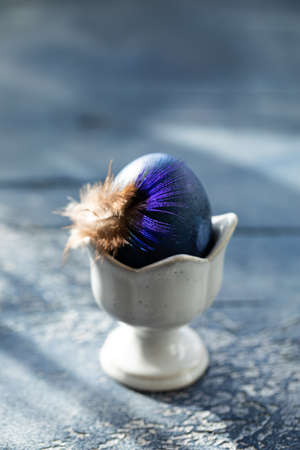 Dyed Easter egg with marble stone effect painted with natural dye carcade tea from hibiscus flowers on old backgroundの写真素材