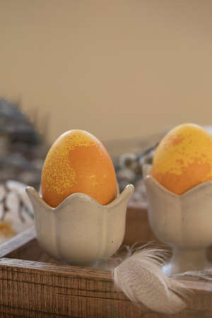 Dyed Easter eggs with marble stone effect painted with natural dye by turmeric on old backgroundの写真素材