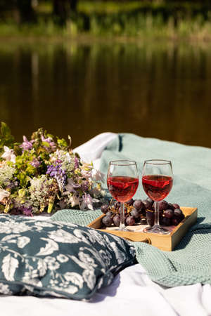 Romantic summer lunch on a mattress floating in the lake or pondの写真素材