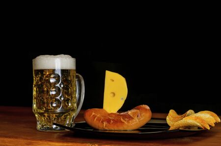 Beer and sausages on a dark background - sailboatの写真素材