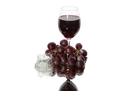 The reflection of a glass of wine with grapes and the fallen dropの写真素材