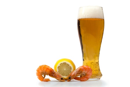 A glass of beer, lemon and shrimp on a white backgroundの写真素材