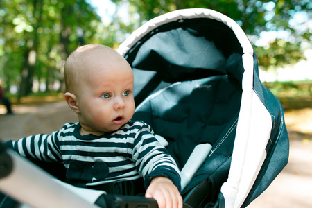 child sitting in a wheelchair, and his mouth opened in surpriseの写真素材