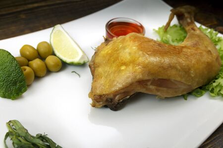 fried chicken leg on a plateの写真素材