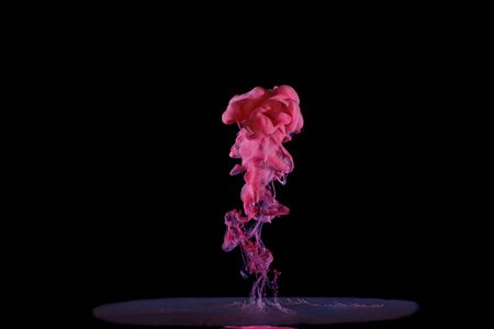 fluid red paint moving in liquidの写真素材