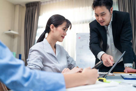 Asian attractive businesswoman work on computer for business project, follow direction from...