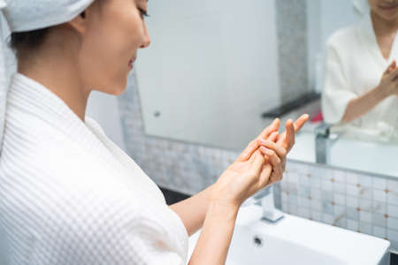 Asian beautiful woman putting smooth and skin care for facial soft. Attractive female touches on...