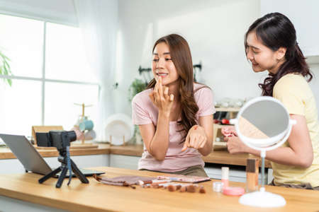 Asian lesbian vlogger talk with camera to review the cosmetic at home. Beautiful Beauty blogger...